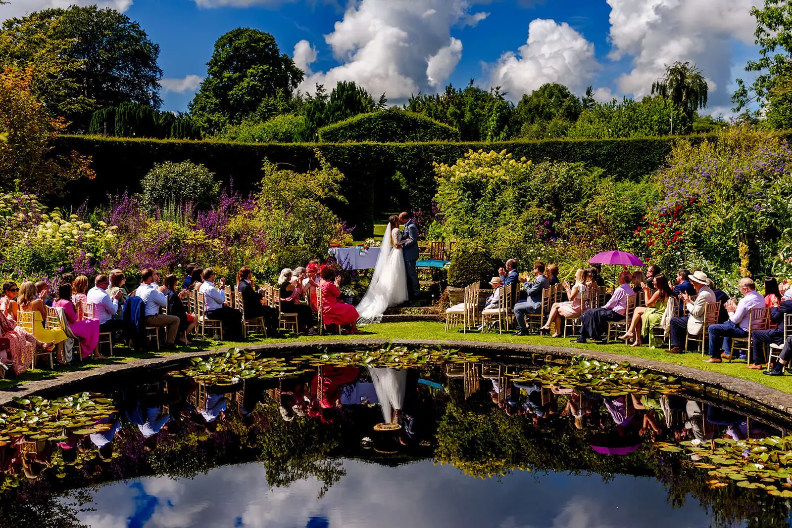 bride and groom by pond getting married in Ballintubbert House